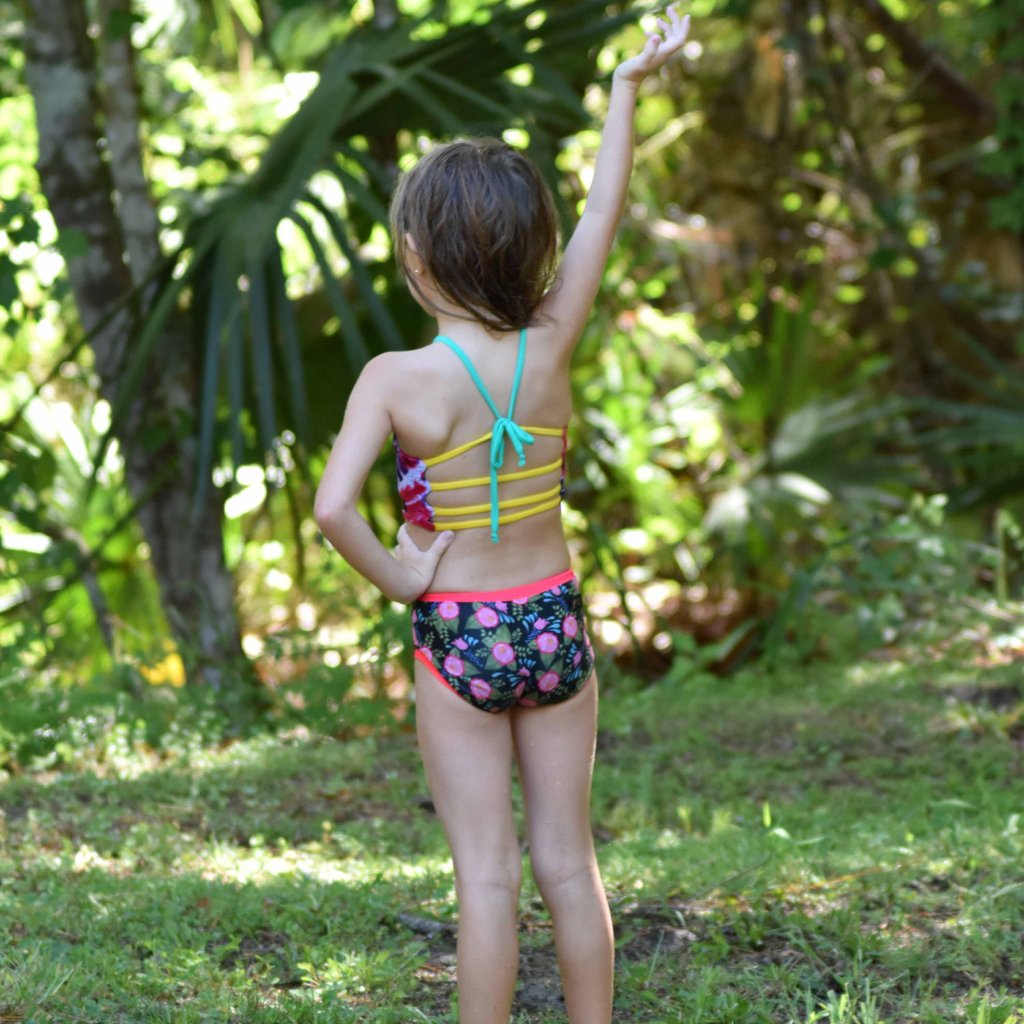 Customizable and reversible swim bottoms for girls, made with eco-friendly material.