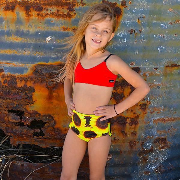 Customizable and reversible sporty swim top for girls, made with eco-friendly material.